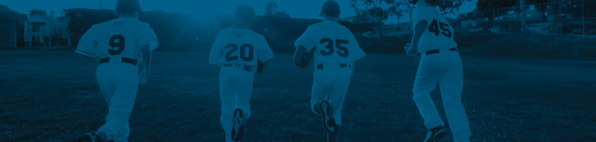 four baseball players running